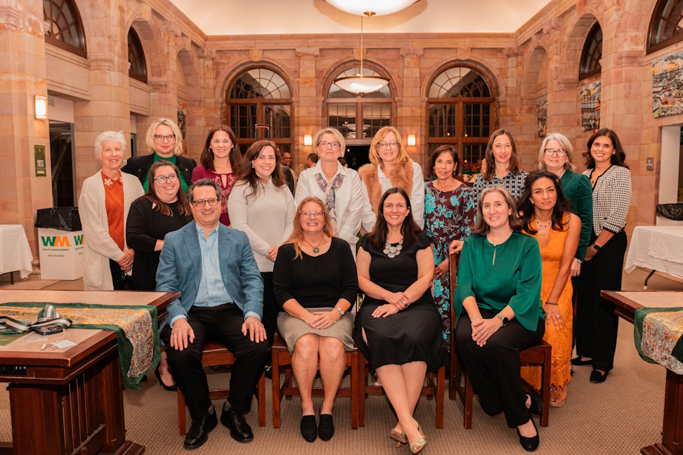 Friends of the Sewickley Public Library Board Members with four members sitting in front row and additional members standing behind in the library's reference department
