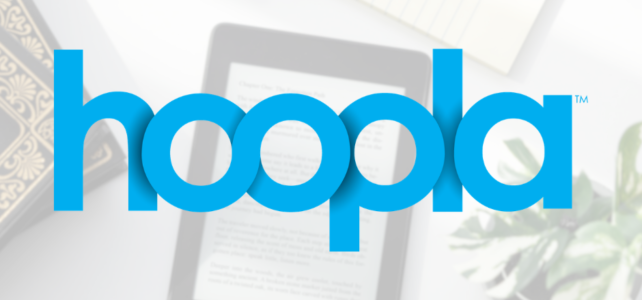 hoopla logo over image of ereader on desk with books, glasses and a plant