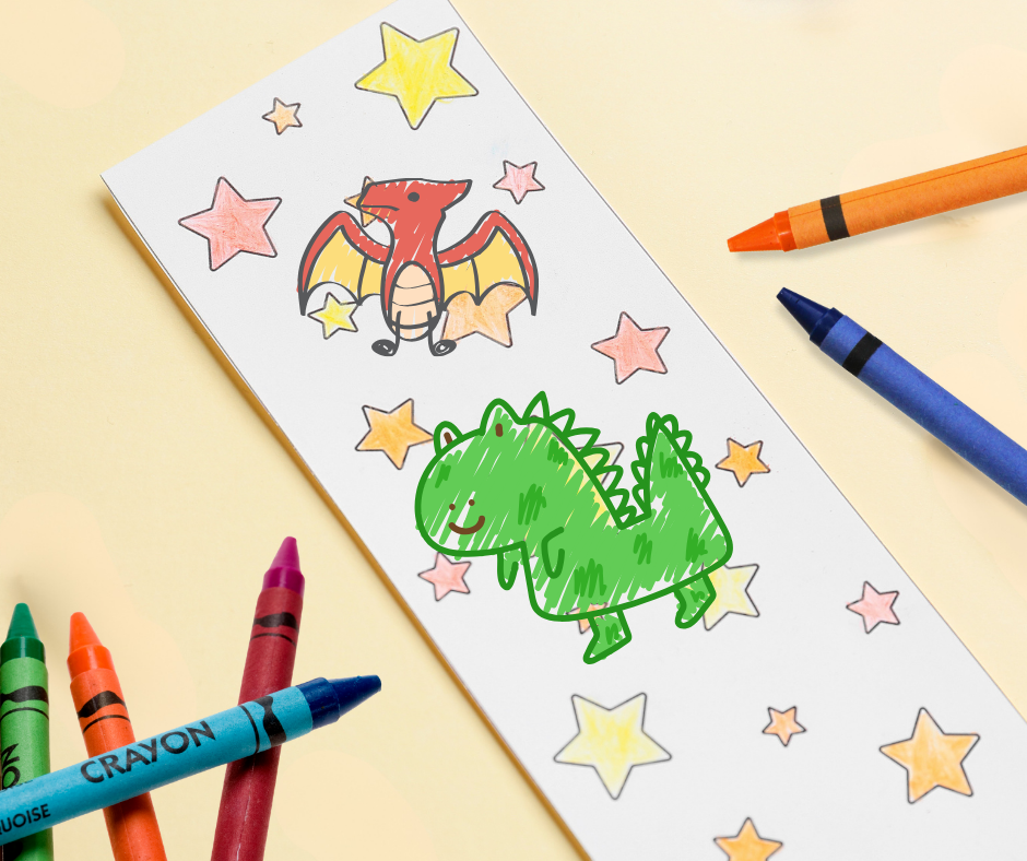 Bookmark with stars and dino drawings next to crayons